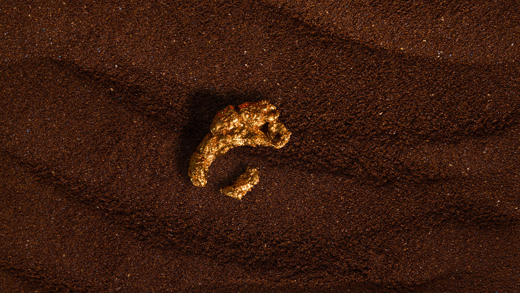 Gold footprints embedded in sand